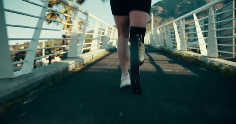 Running, amputee and legs of runner in city for training, adaptive and cardio Stock Footage 287419544