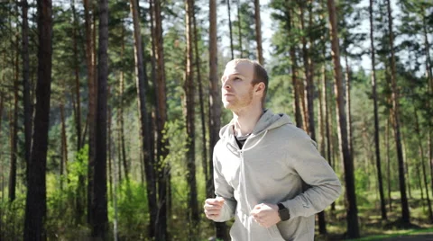 Running athlete man looking at smartwatch heart rate monitor GPS Видео 63029485