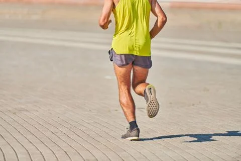 Running athletic man. Stock Photos