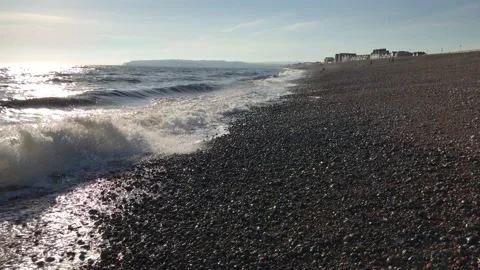 Running aways from the waves at the beach Stock Footage 130875793