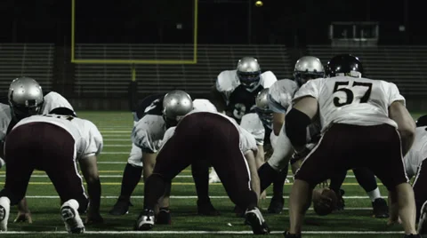 A running back takes a hand off from the QB dives over the line of scrimmage Video stock 33871032