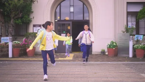 Running with a Backpack: An Elementary School Student Stock Footage 332750991