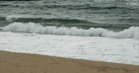 Running on the Beach in front of Big Waves, Slowmotion Stock Footage 115833703