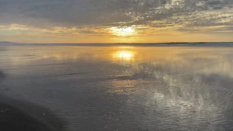 Running on an beach at low tide with sunset reflection Video stock 329449109
