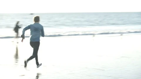 Running At Birds On Beach Stock Footage 129861287