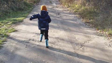 Running Boy In Rubber Boots Slow Motion Stock Footage 144333259