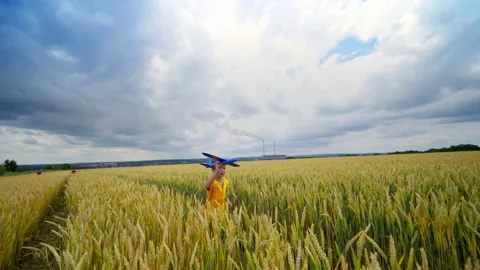 Running boy with toy plane Stock Footage 135985366