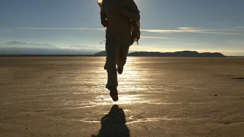 Running to camera man in desert on sunset Stock Footage 117224653