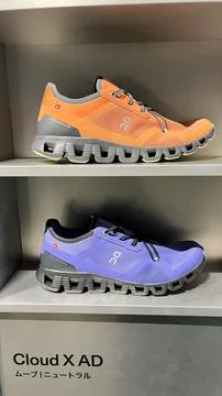 On Running Cloud X AD specialized sneakers displayed on retail shelving at .. Stock Photos
