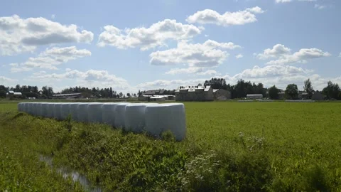 Running clouds and sloping field Stock Footage 136364085