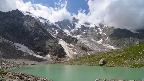 Running clouds over Monte Rosa and Locce lake 4k time-lapse, Italy Stock Footage