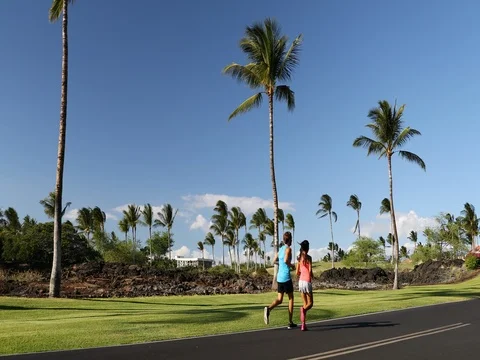Running couple jogging on road exercising together Stock Footage 76801038