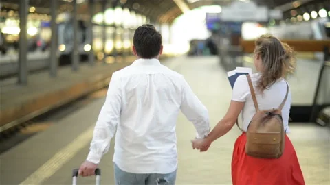 Running Couple With A Suitcase In A Train Station. Woman Holding Passports In Stock Footage 111140261