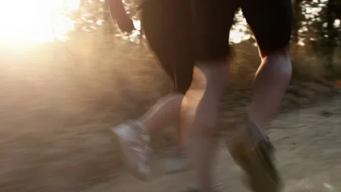 Running couple on a trail at sunrise, close up shoes steadicam shot Stock-Footage 199630557