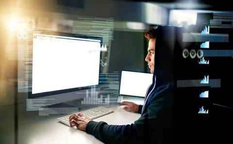 Running diagnostics on his system. a handsome young male computer programmer Stock Photos