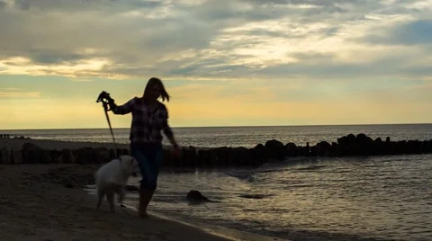 Running With a Dog Along the Seashore Stock Footage 67456316