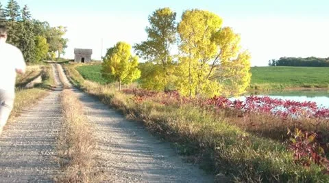 Running Down Dirt Road in Fall 動画素材 12613061