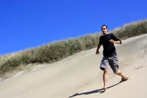 Running down the dunes Stock Photos