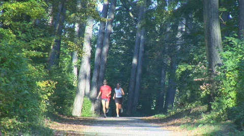 Running down road upper body Stock Footage 87388