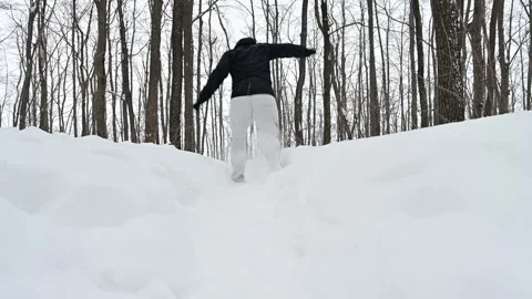 Running down a snowy mountain path as winter magic unfolds Stock Footage 338414338