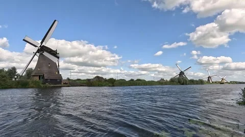 Running Dutch windmills with turning sails at Kinderdijk, Netherlands Stock Footage 345710236