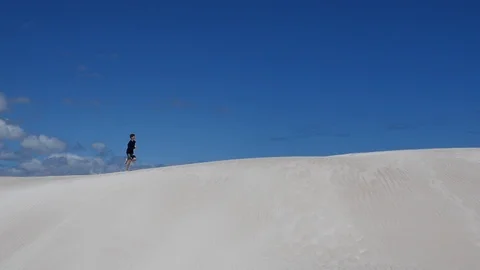 Running with endurance and stamina on hot desert sand Stock Footage 106939059