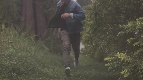 Running guy in the garden 스톡 동영상 243095811