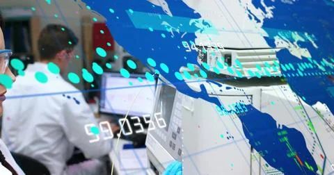 Running lab techs checking lab analyzer wearing lab coats blue gloves goggles 写真素材