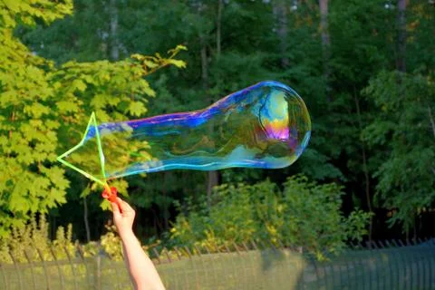 Running a large soap bubble.	 Stock Photos