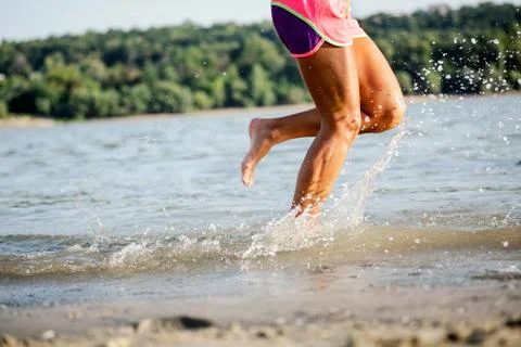 Running legs of runner jogging on beach Stock Photos