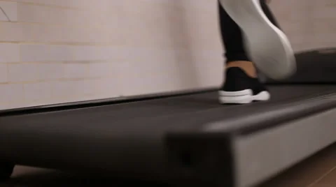 Running legs on a treadmill Stock Footage 60942976