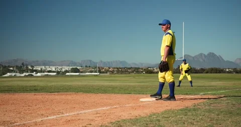 Running male pitcher onto mound at baseball field warming up, fielding throw and Stock Footage 340256690