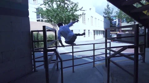Running Man Does Parkour in Business Suit - Slow Motion. Angle from Behind Stock Footage 50481660