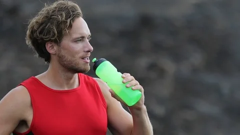 Running man drinking water from bottle - portrait of male runner resting Stock Footage 70276429