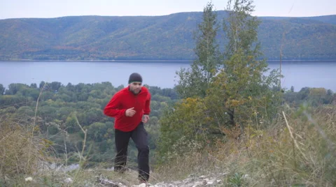 Running man trail runner in cross-country training run. Male athlete sports r Stock Footage