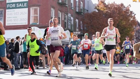 Running NYC Marathon in Slow Motion. People running, many participant low angle Stock Footage 132463025