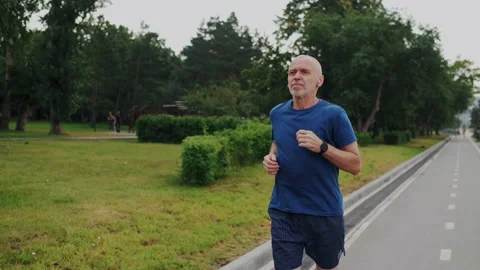 Running or Jogging in Park in Old Age. Male Elegant Gray-Haired Grandfather Stock Footage 148468297
