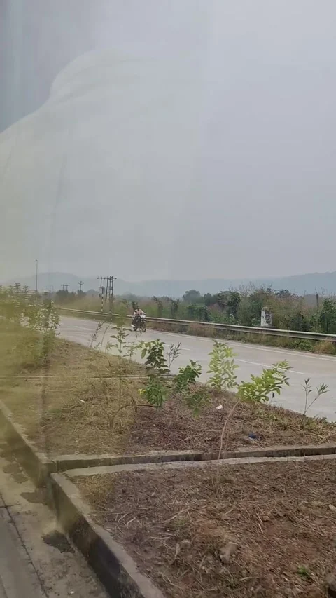 Running outside the car window, with trees and a cloudy sky 動画素材 293243985