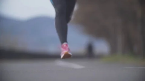 Running in the park. Close-up. Slow motion. Video stock 70952905