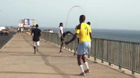 Running people at corniche road in Dakar, Senegal, Africa Stock Footage