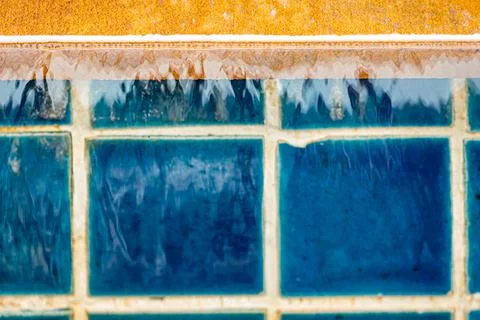 Running pool water in blue bricks background Stock Photos