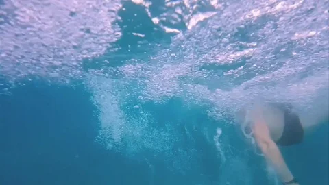 Running into pool from water slide in slow motion Stock Footage