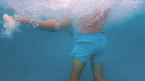 Running into pool from water slide in slow motion Stock Footage 80698252