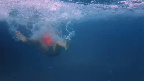 Running into pool from water slide in slow motion Stock Footage