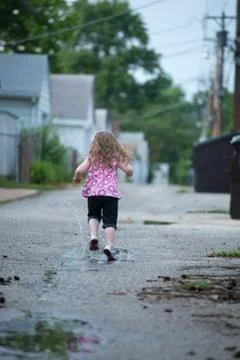 Running in puddles Stock Photos