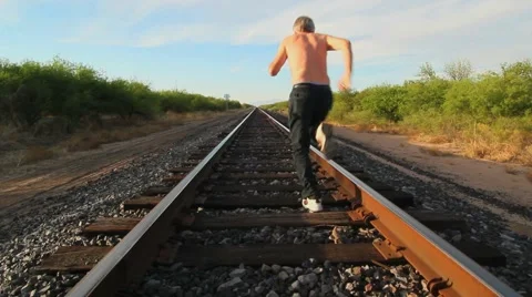 Running On Railroad Tracks Stock Footage