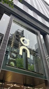 On Running retail store facade featuring the iconic white brand logo on a g.. Stock Photos