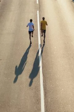 Running on the road Stock Photos