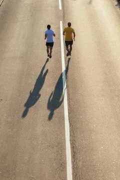 Running on the road Stock Photos