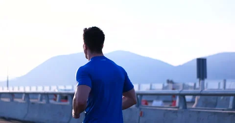 Running runner man athlete training outdoors exercising on mountain road at s Stock Footage 67236895